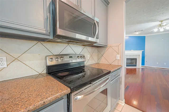 a kitchen with stainless steel appliances granite countertop a stove and a microwave