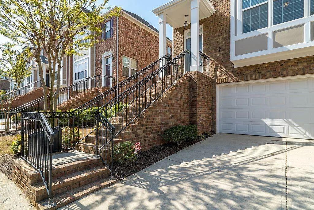 6120 Joybrook Road Duluth, GA 30097 - Photo 2 of 30 a view of a brick house with many windows
