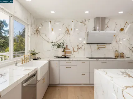 a kitchen with granite countertop a sink stove and cabinets