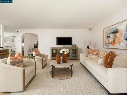 a living room with furniture and a floor to ceiling window