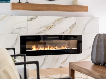 a picture of a fireplace with a rug