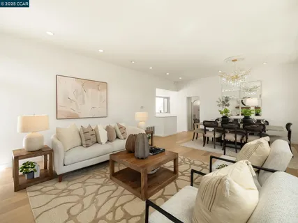 a living room with furniture a fireplace and a floor to ceiling window
