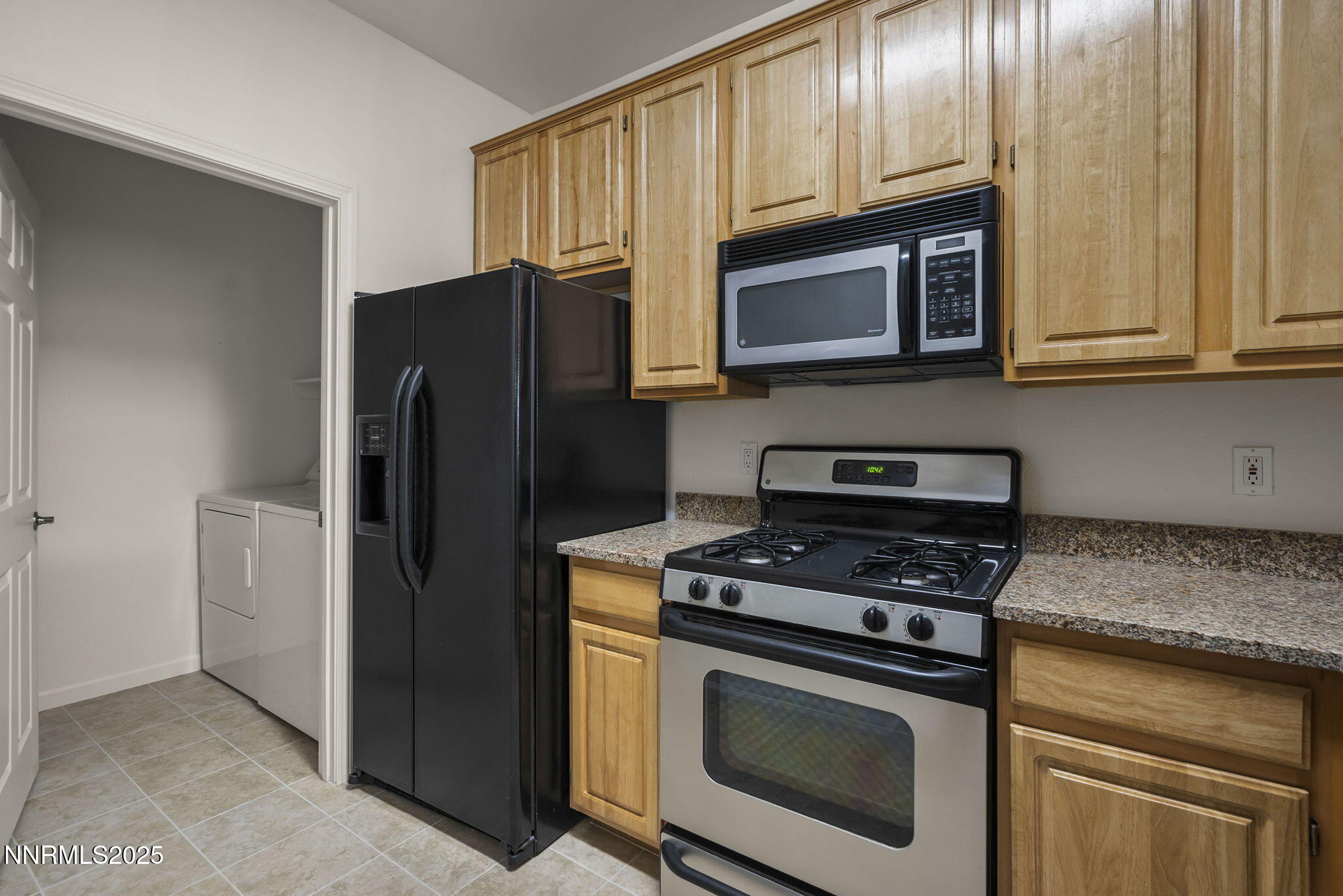 900 South Meadows Parkway, Unit 622 Reno, NV 89521 - Photo 12 of 30 a kitchen with stainless steel appliances granite countertop a refrigerator stove and microwave