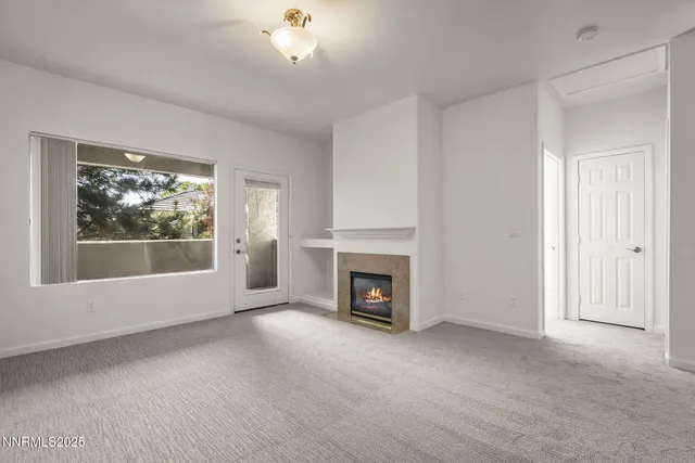 a view of empty room with a fireplace