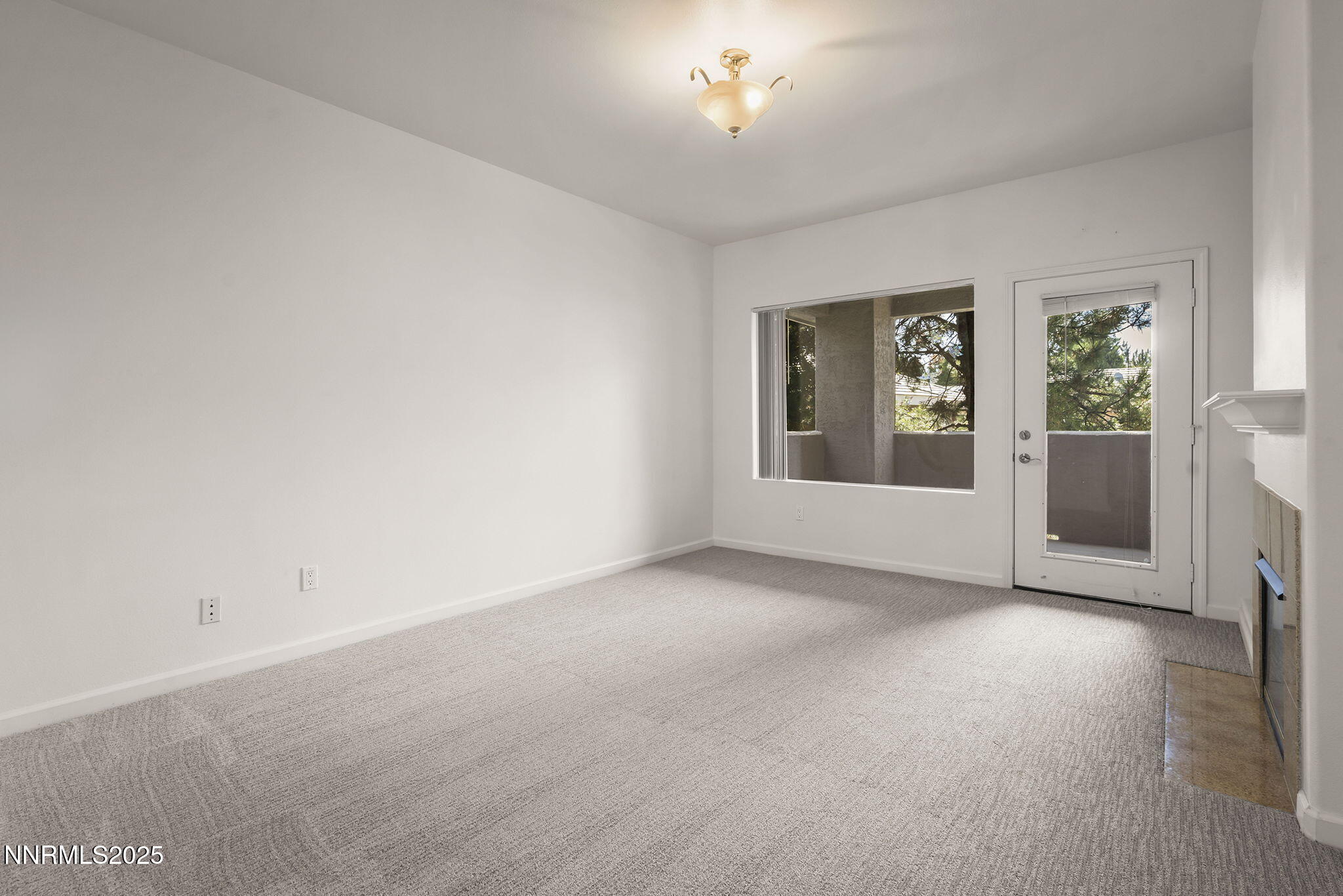 900 South Meadows Parkway, Unit 622 Reno, NV 89521 - Photo 5 of 30 an empty room with windows and fireplace