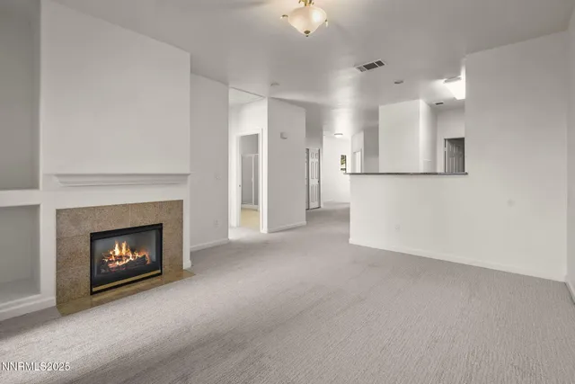 a view of empty room with a fireplace