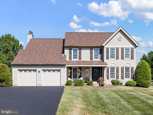 a front view of a house with a yard outdoor seating and garage