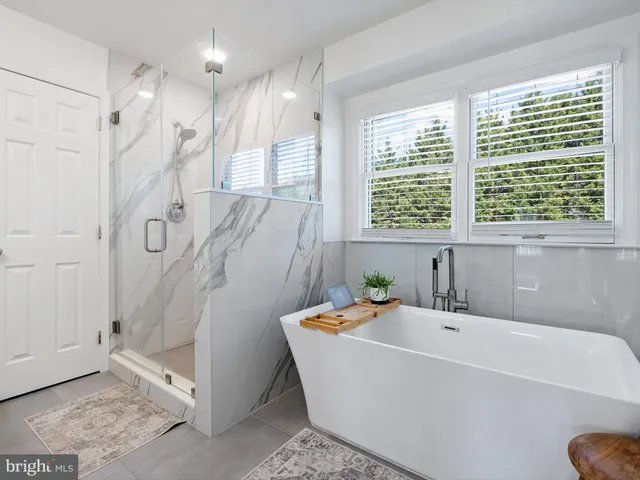 a bathroom with a bathtub and a shower