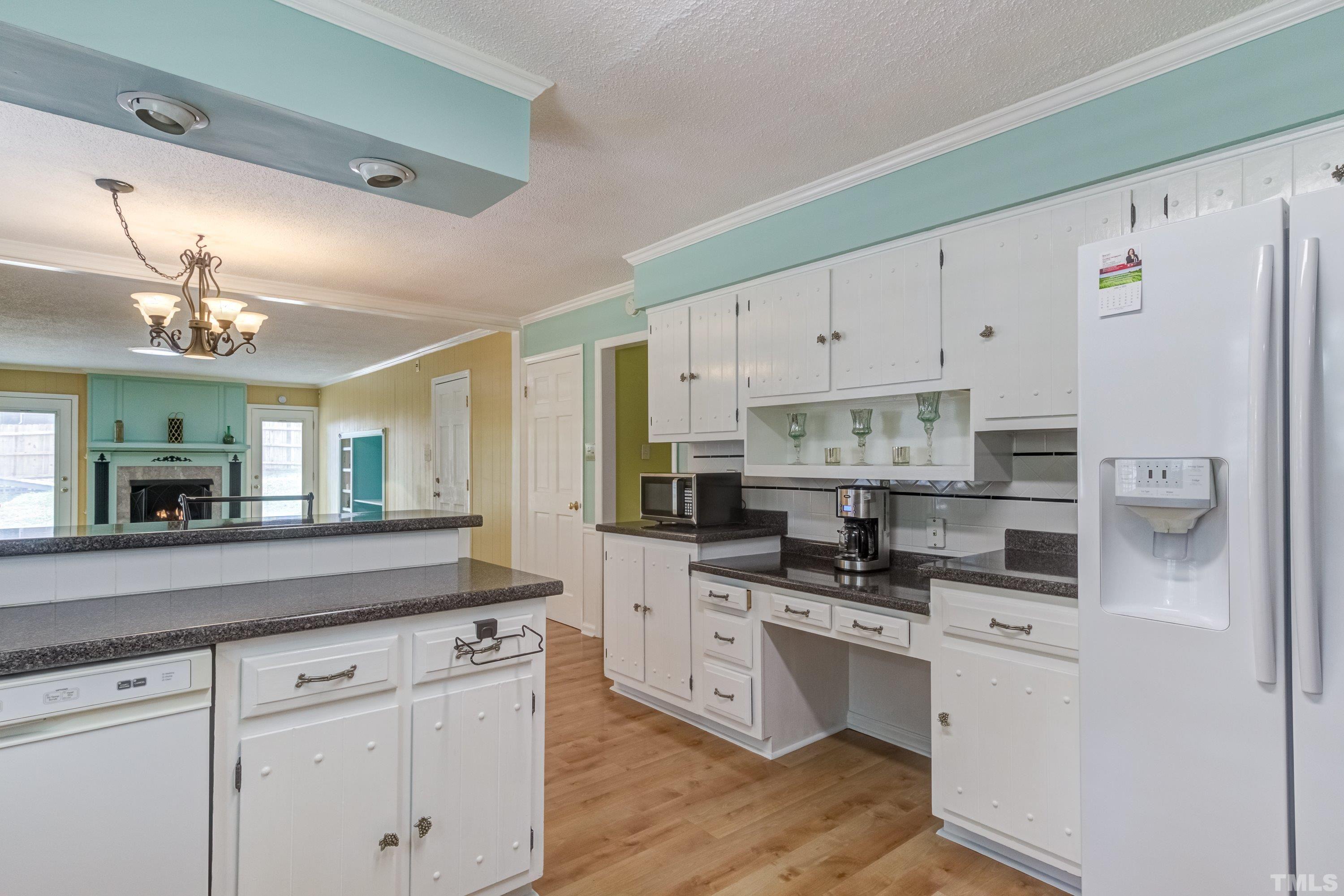 3108 Beane Drive Raleigh, NC 27604 - Photo 23 of 51 a kitchen with white cabinets and stainless steel appliances