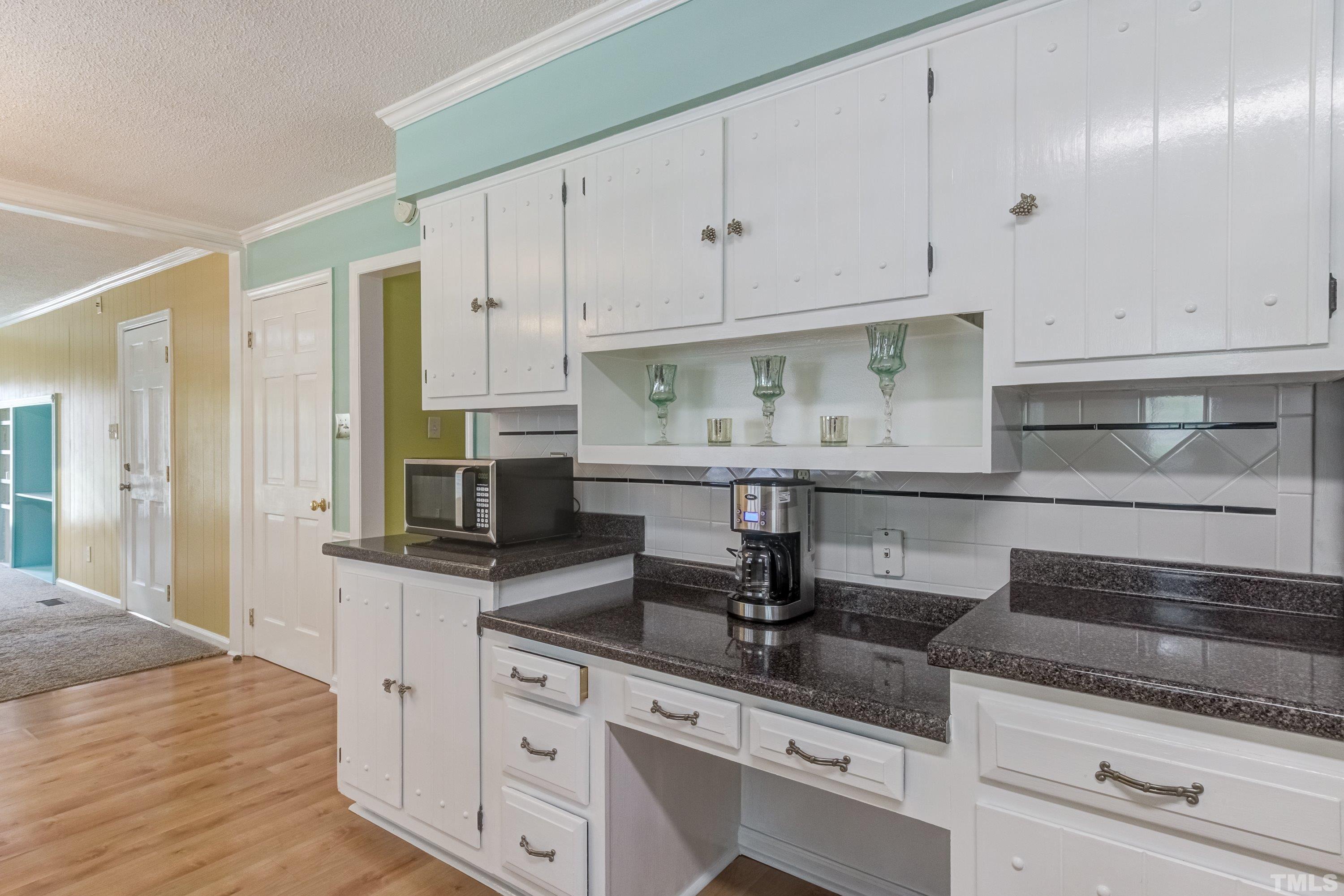 3108 Beane Drive Raleigh, NC 27604 - Photo 24 of 51 a kitchen with granite countertop white cabinets and stainless steel appliances