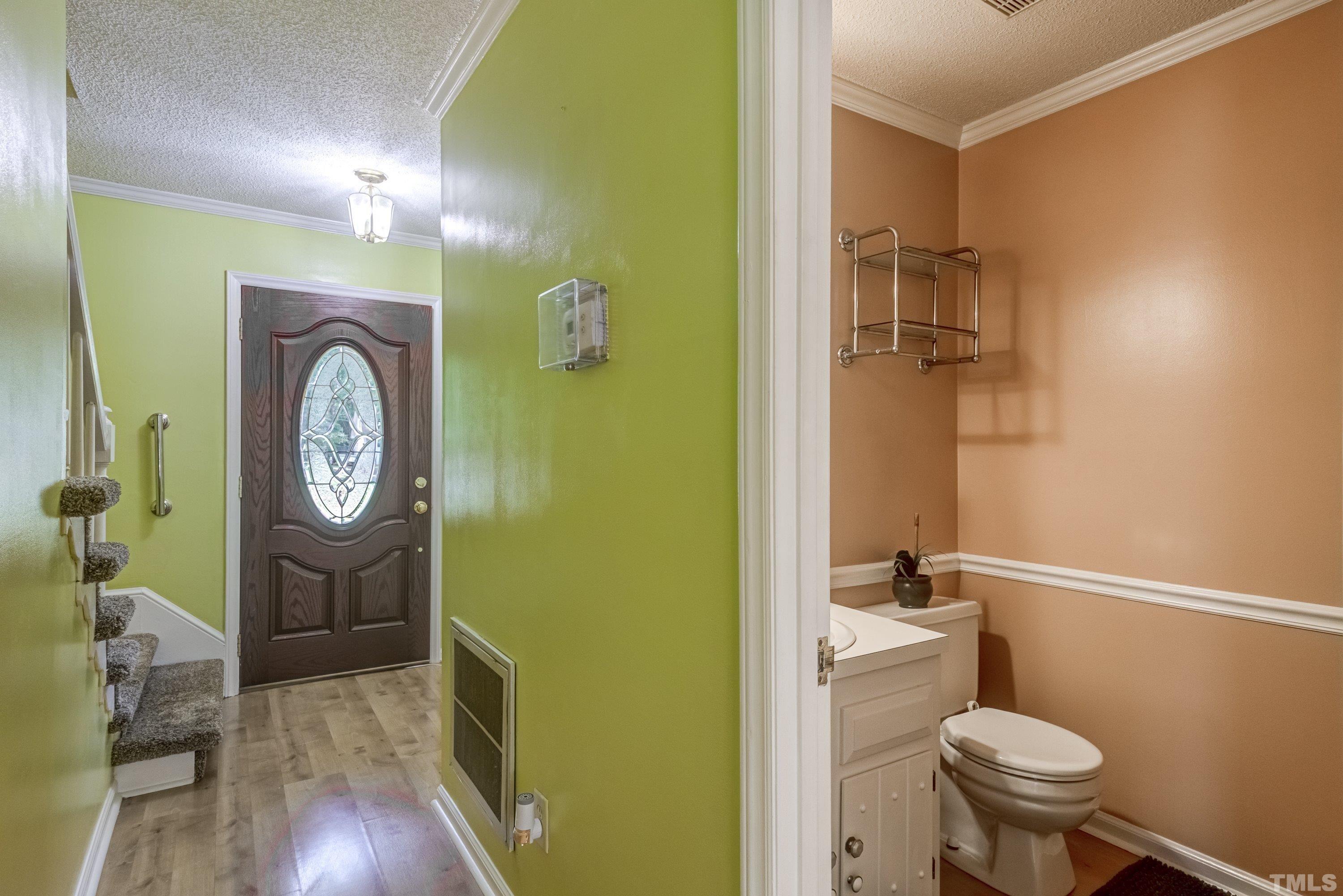 3108 Beane Drive Raleigh, NC 27604 - Photo 4 of 51 a bathroom with a toilet a sink and a mirror