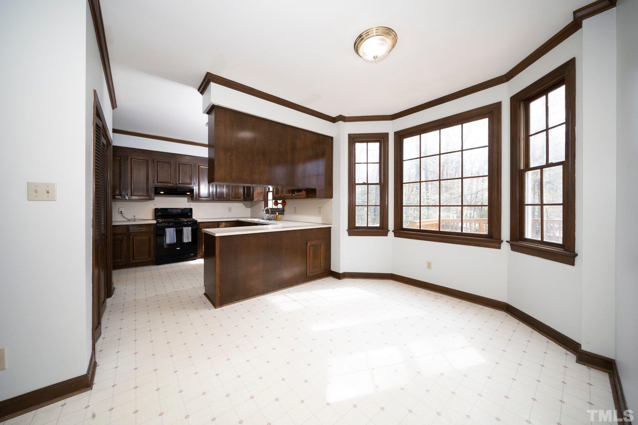 8612 Mourning Dove Road Raleigh, NC 27615 - Photo 11 of 29 a open kitchen with stainless steel appliances granite countertop a refrigerator a sink dishwasher a stove and a microwave oven with wooden floor