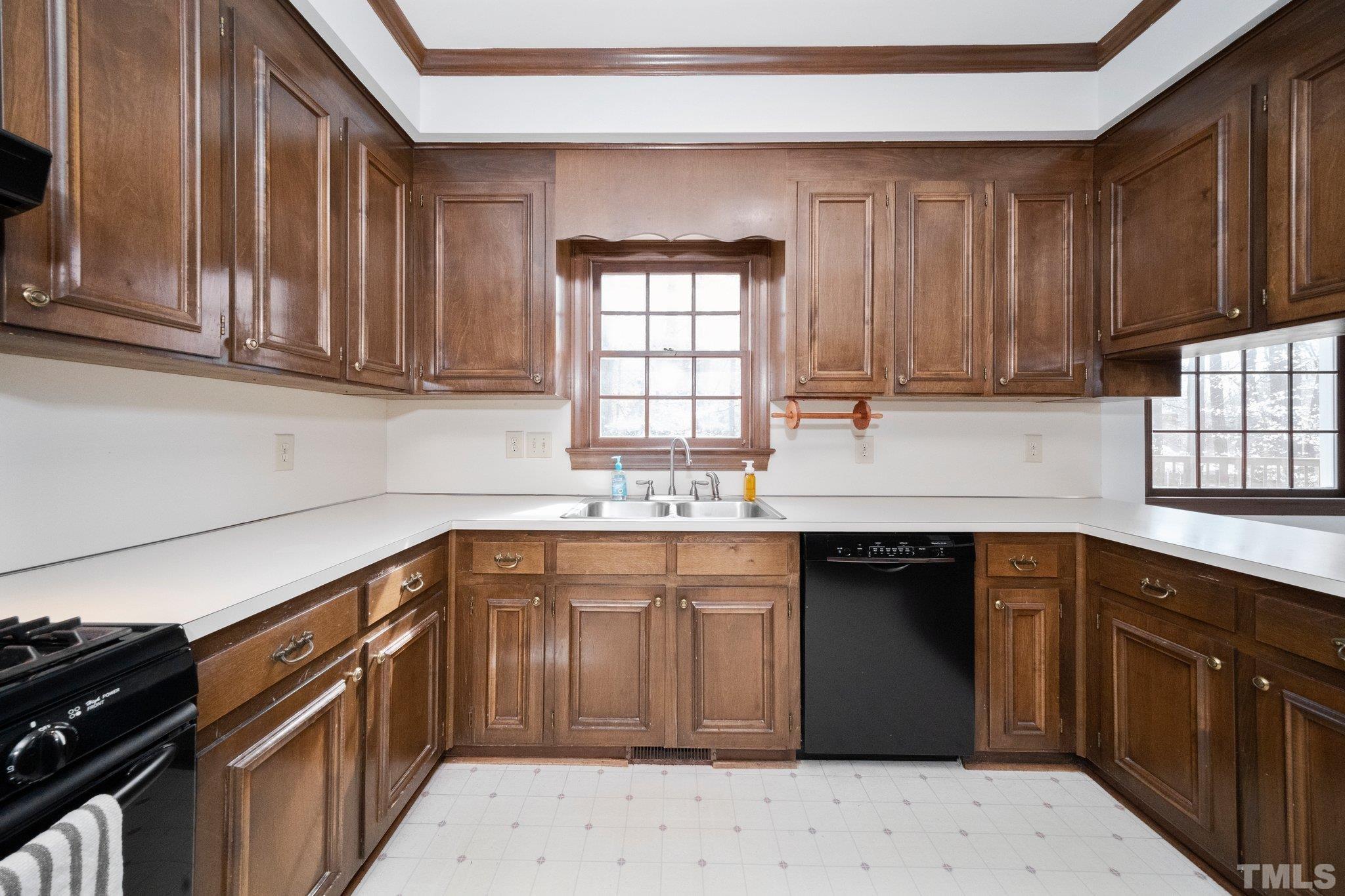 8612 Mourning Dove Road Raleigh, NC 27615 - Photo 13 of 29 a kitchen with stainless steel appliances granite countertop a sink stove and cabinets