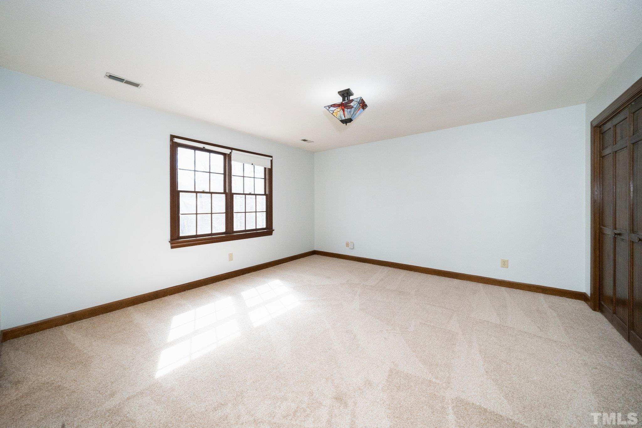8612 Mourning Dove Road Raleigh, NC 27615 - Photo 16 of 29 an empty room with windows and ceiling fan