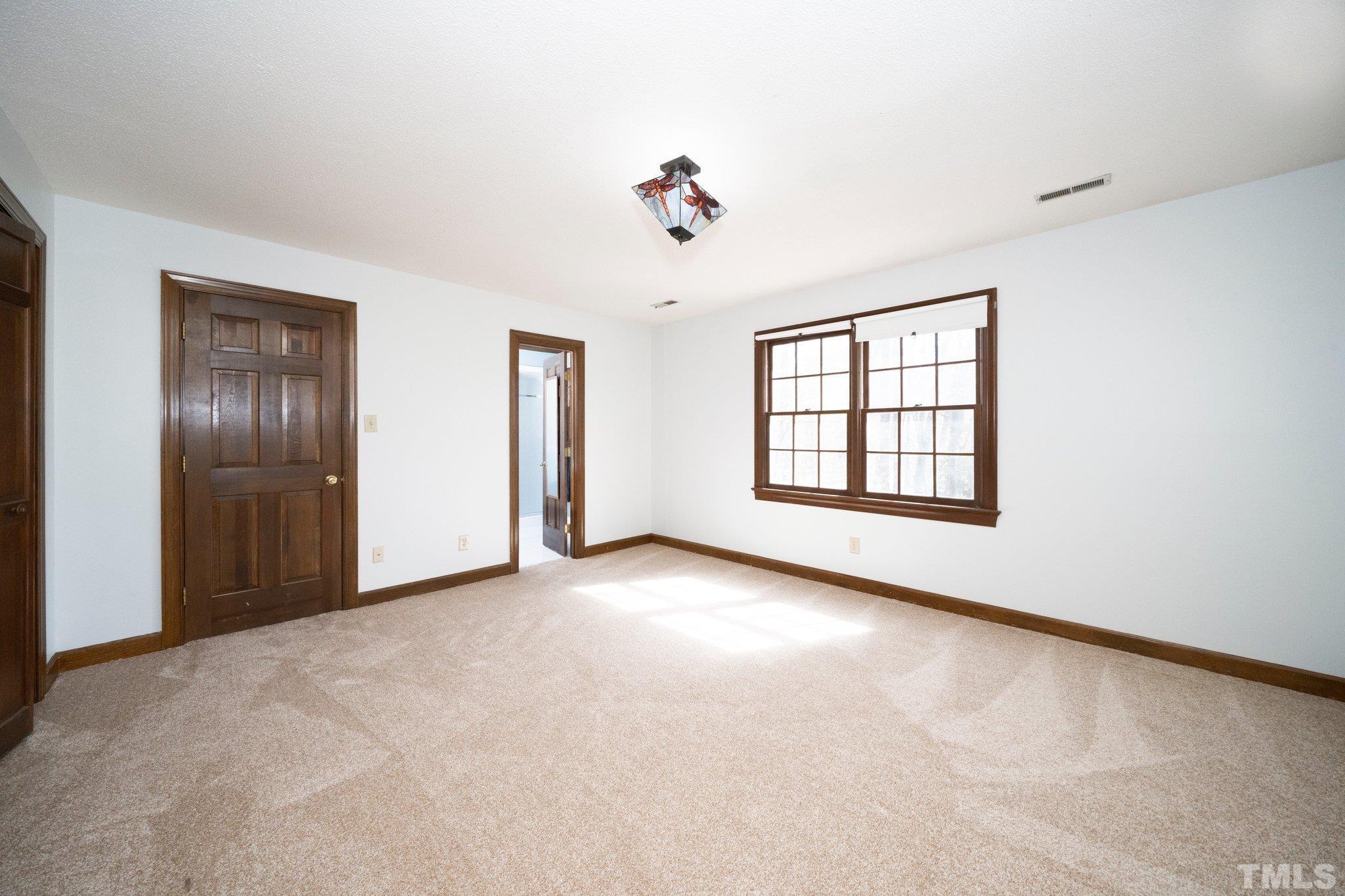 8612 Mourning Dove Road Raleigh, NC 27615 - Photo 17 of 29 an empty room with windows and cabinet