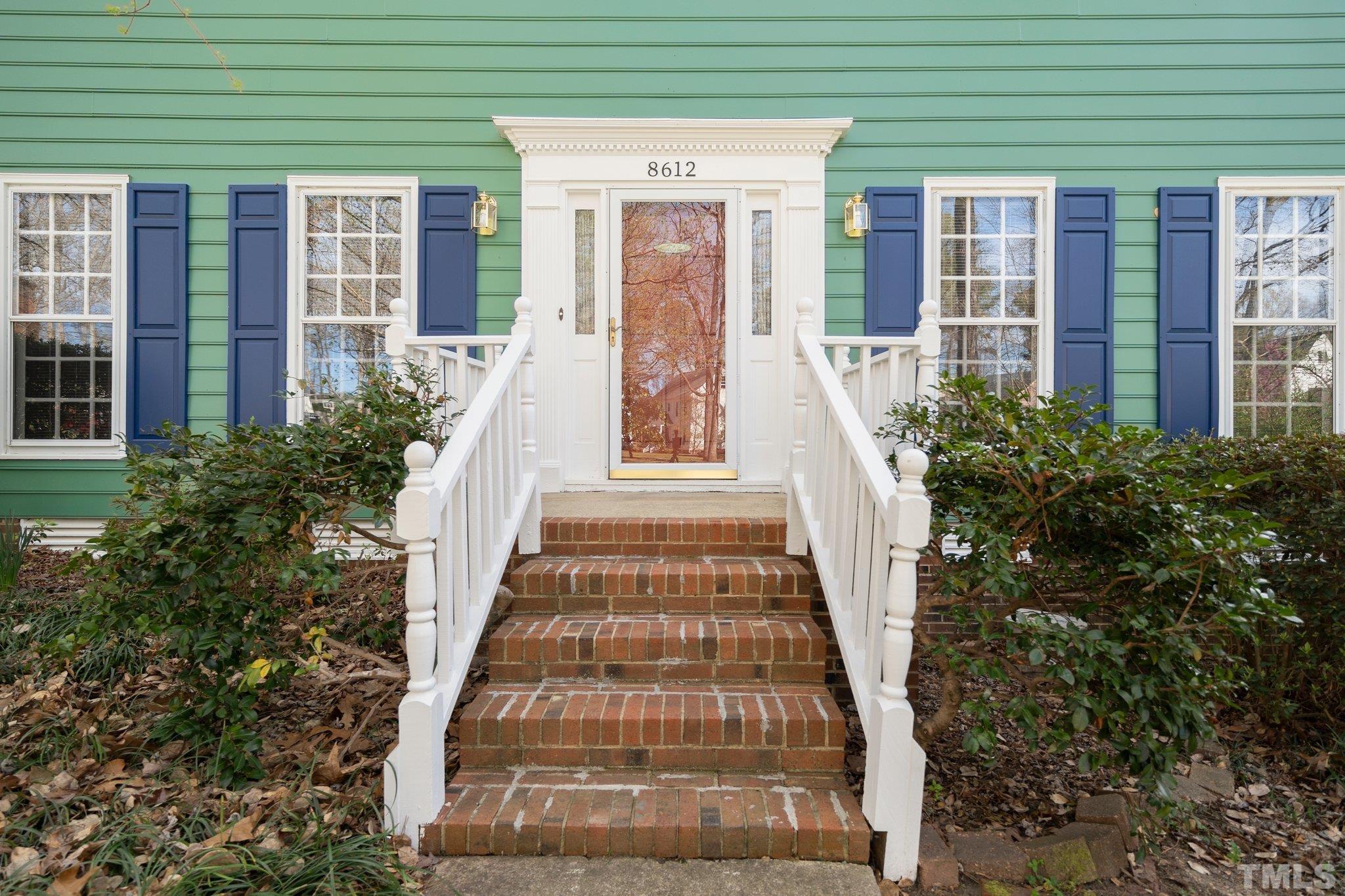 8612 Mourning Dove Road Raleigh, NC 27615 - Photo 2 of 29 a view of a brick house with large windows