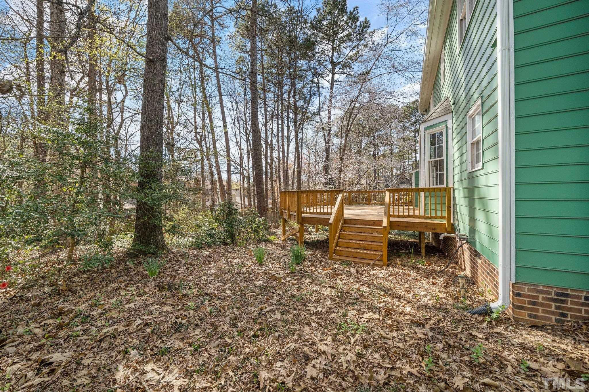 8612 Mourning Dove Road Raleigh, NC 27615 - Photo 28 of 29 a backyard of a house with table and chairs