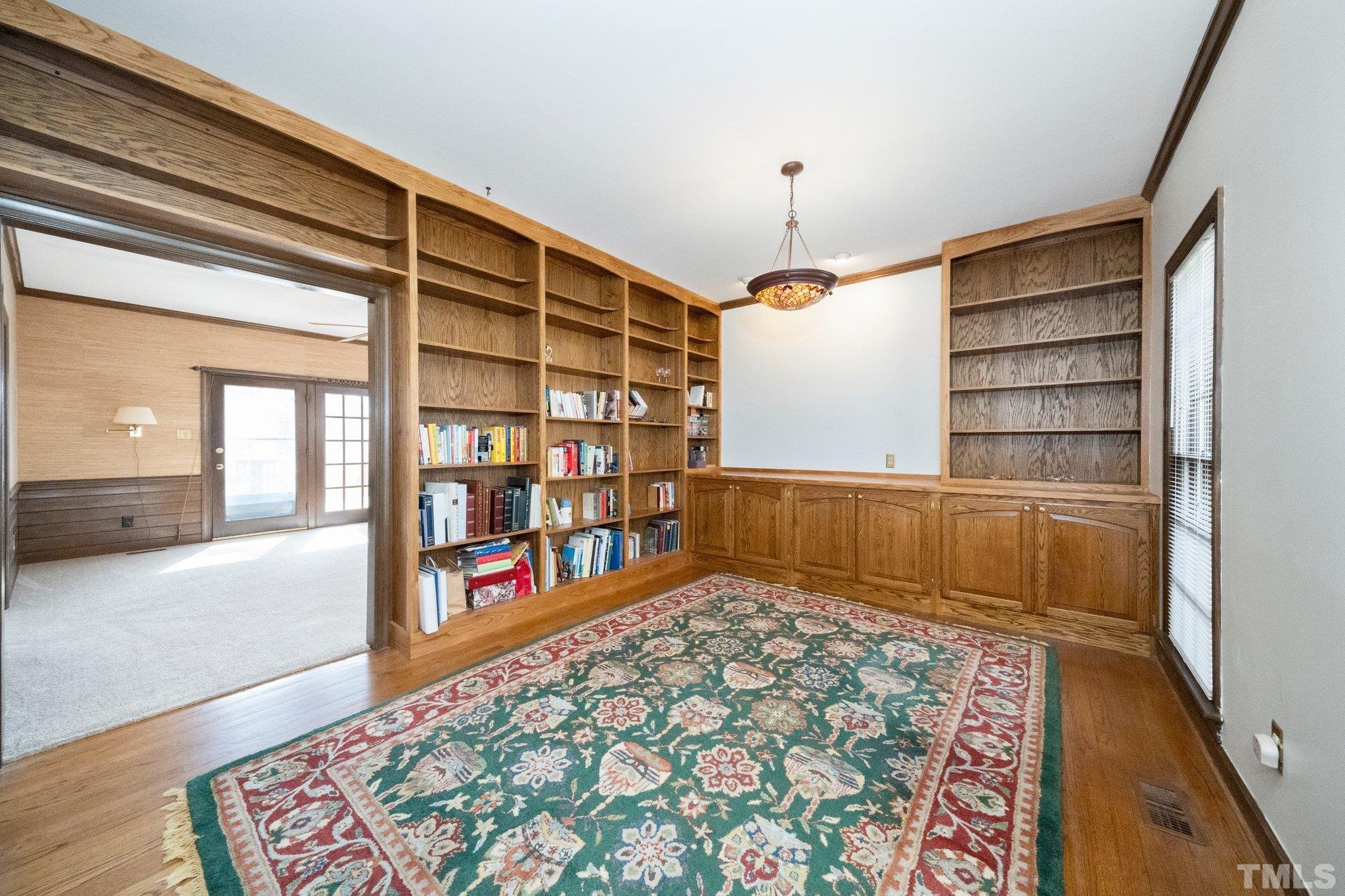 8612 Mourning Dove Road Raleigh, NC 27615 - Photo 6 of 29 a living room with a couch and a bookshelf