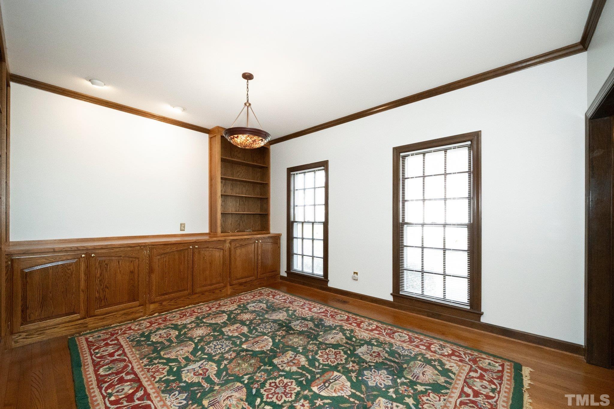 8612 Mourning Dove Road Raleigh, NC 27615 - Photo 7 of 29 wooden floor in an empty room with a window