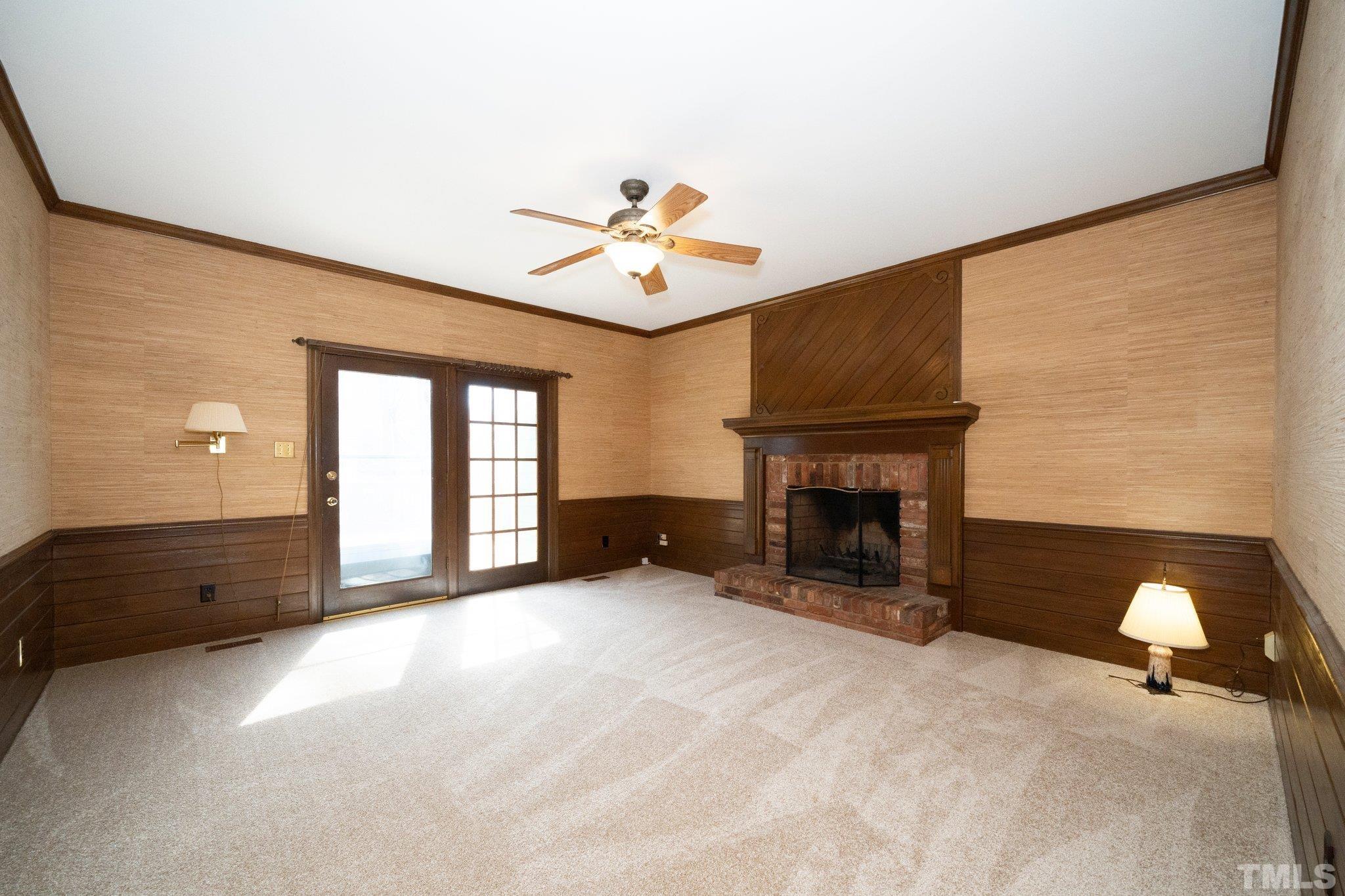 8612 Mourning Dove Road Raleigh, NC 27615 - Photo 9 of 29 a view of an empty room with a fireplace and a window