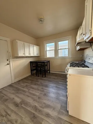 a kitchen with a refrigerator and a table