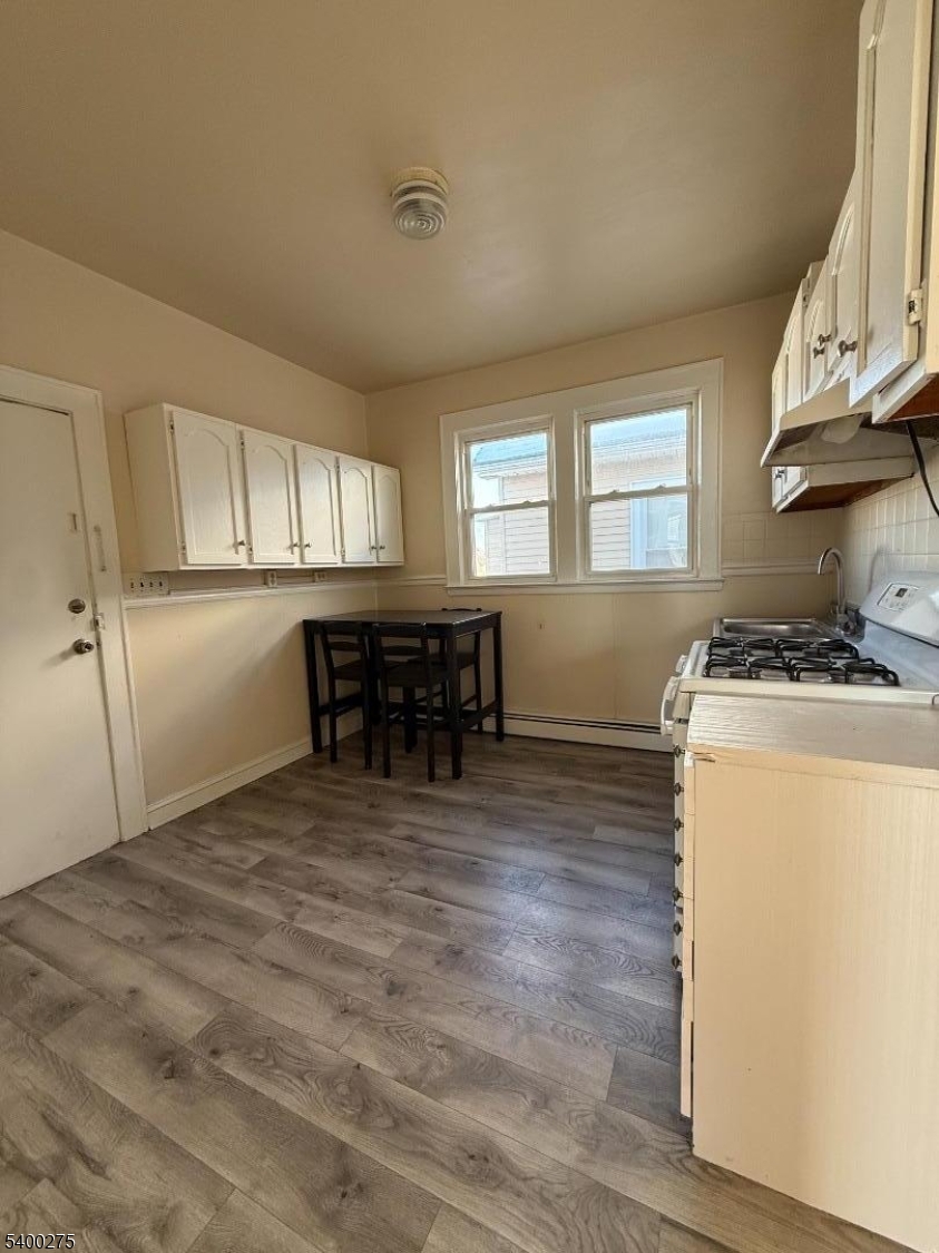 1010 Kilsyth Road Elizabeth, NJ 07208 - Photo 3 of 9 a kitchen with a refrigerator and a table