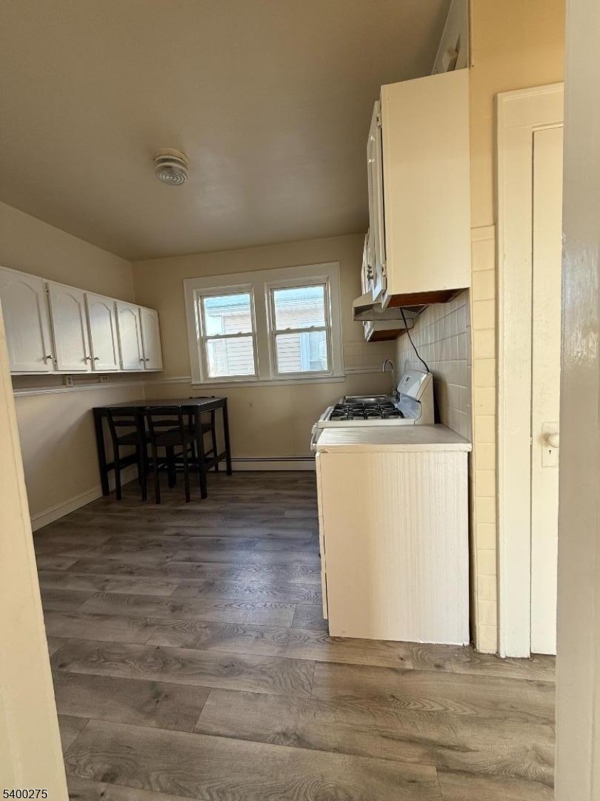 1010 Kilsyth Road Elizabeth, NJ 07208 - Photo 4 of 9 a kitchen with stainless steel appliances granite countertop a table chairs and a refrigerator