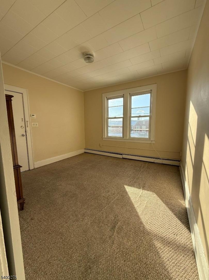 1010 Kilsyth Road Elizabeth, NJ 07208 - Photo 5 of 9 an empty room with windows
