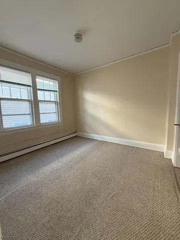 an empty room with a empty space and windows