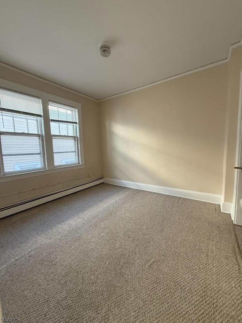 1010 Kilsyth Road Elizabeth, NJ 07208 - Photo 6 of 9 an empty room with a empty space and windows