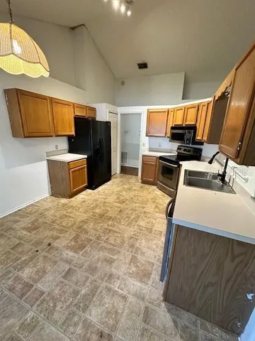 a kitchen with a stove and a refrigerator