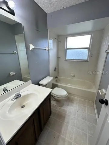 a bathroom with a sink a toilet and a bathtub