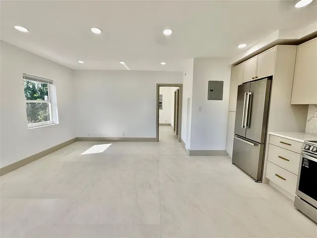 a view of a kitchen with a refrigerator a sink dryer and a refrigerator
