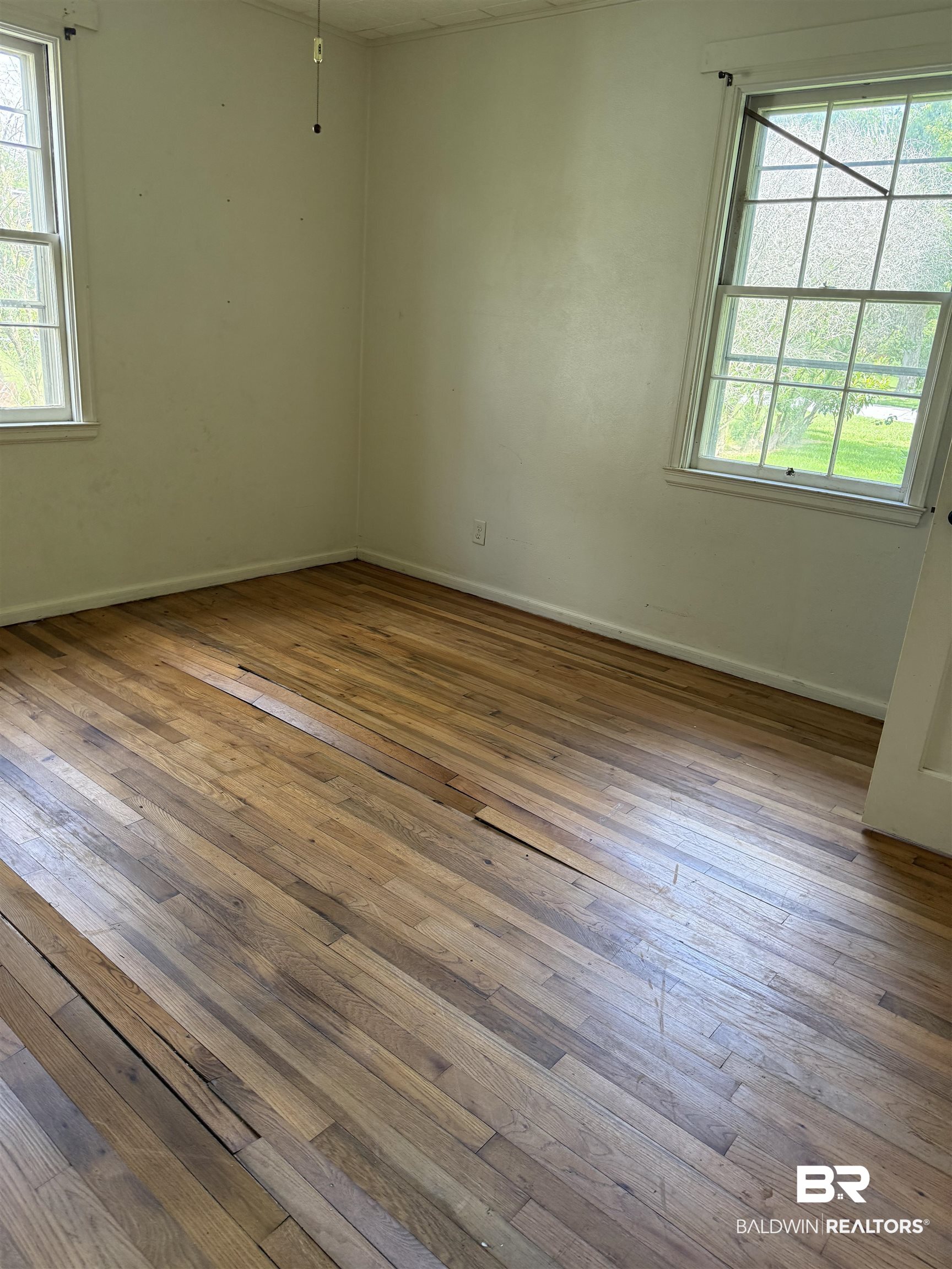 502 East Myrtle Avenue Foley, AL 36535 - Photo 6 of 9 Spare room with wood-type flooring and healthy amount of natural light