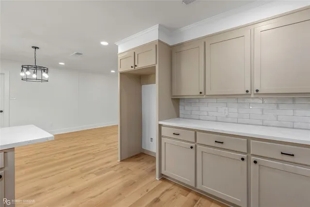 a kitchen with granite countertop white cabinets and white appliances
