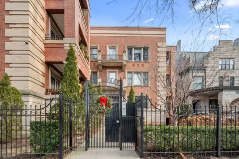 a front view of a multi story residential apartment building with yard