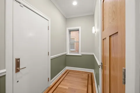 a view of empty room with wooden floor