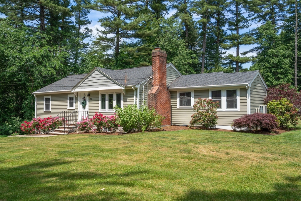 57 Marlboro Road Sudbury, MA 01776 - Photo 35 of 40 a front view of a house with a garden
