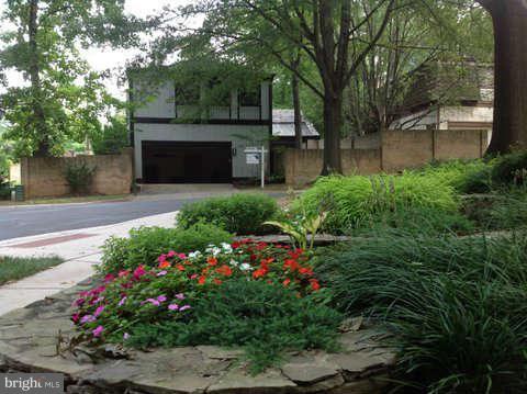 6221 Swords Way Bethesda, MD 20817 - Photo 1 of 12 a view of a garden with flowers and trees