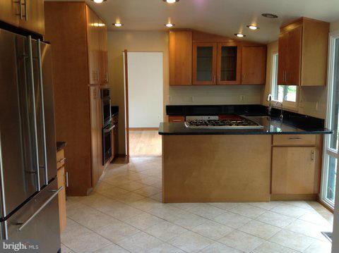 6221 Swords Way Bethesda, MD 20817 - Photo 5 of 12 a kitchen with stainless steel appliances granite countertop a refrigerator and a stove