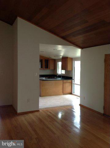 6221 Swords Way Bethesda, MD 20817 - Photo 6 of 12 a large kitchen with cabinets and wooden floor