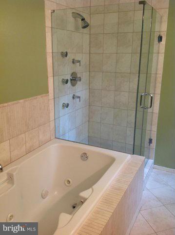 6221 Swords Way Bethesda, MD 20817 - Photo 9 of 12 a bathroom with a bathtub and shower