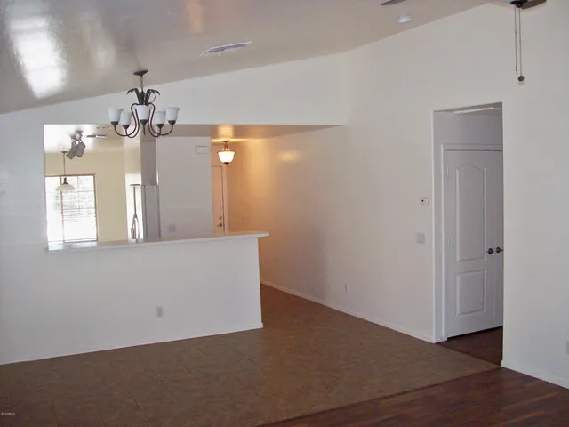a view of a room with wooden floor and chandelier