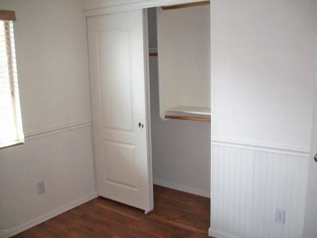 an empty room with wooden floor