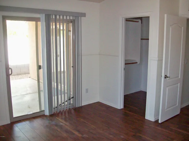 an empty room with wooden floor and a window