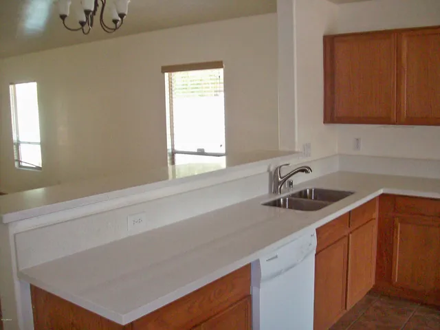 a kitchen with a sink cabinets and a window