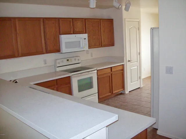 a kitchen with stainless steel appliances a stove top oven a sink and dishwasher