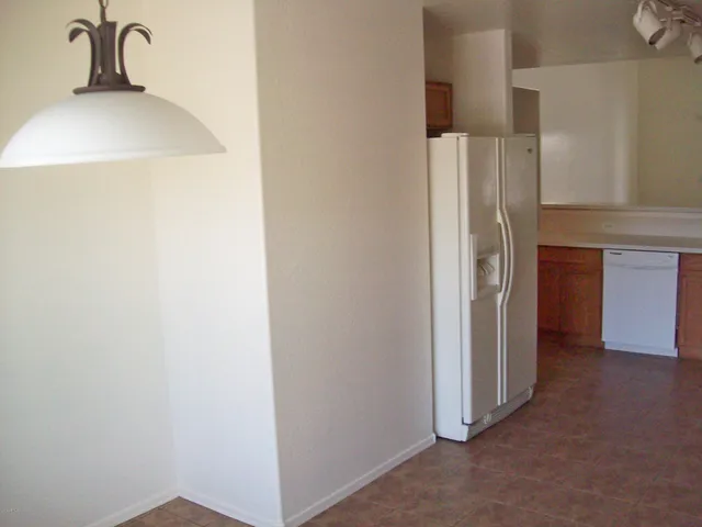 a view of a kitchen from the hallway