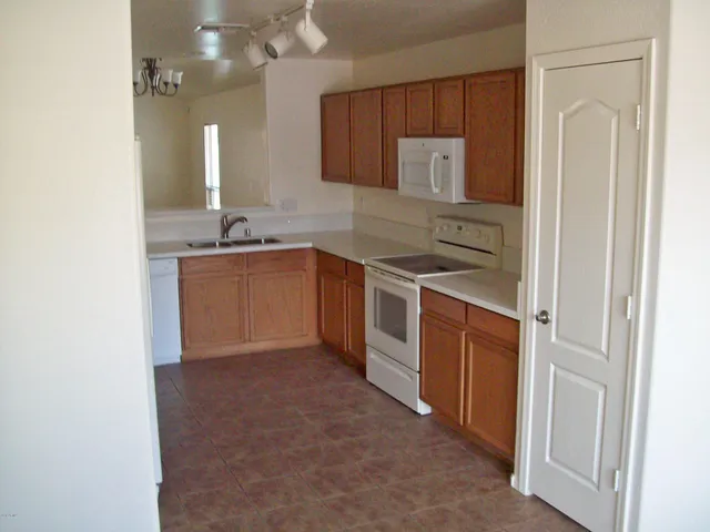 a kitchen with stainless steel appliances granite countertop a sink and a stove