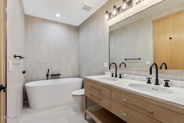 a bathroom with a double vanity sink and a bathtub
